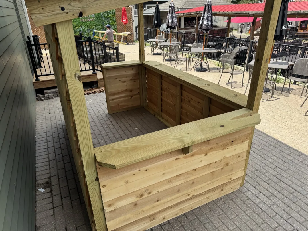Signature Ebbesen Woodworking outdoor bar photographed in a finished backyard setting